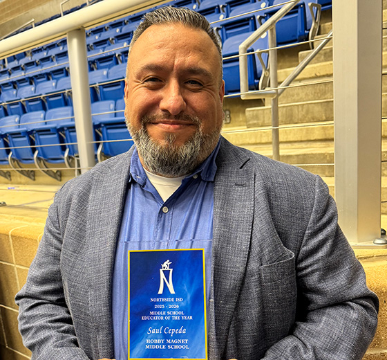 Saul Cepeda holding the award for Northside ISD Middle School Educator of the Year