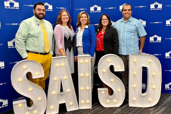 Photo of SAISD Principals with Dr. Juanita Sanos in front of an SAISD sign