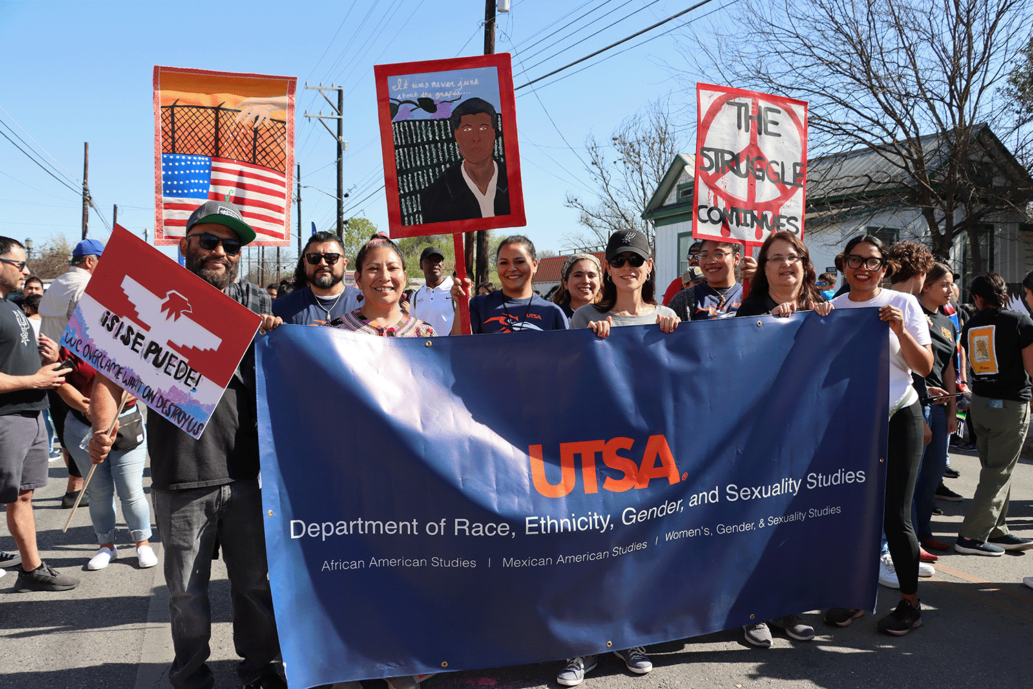 REGSS Faculty at Cesar Chavez March holding department banner