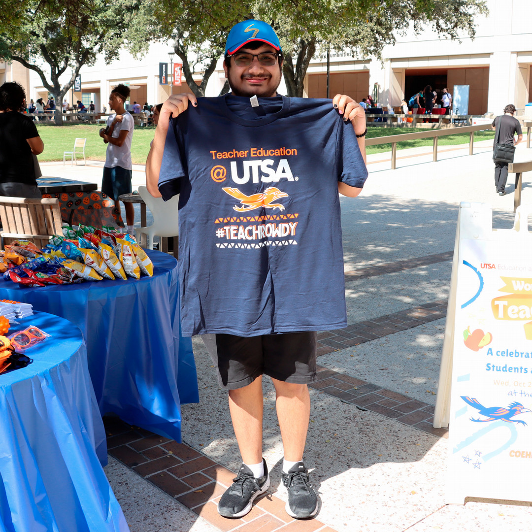 A COEHD student shows off a "Teach Rowdy" shirt