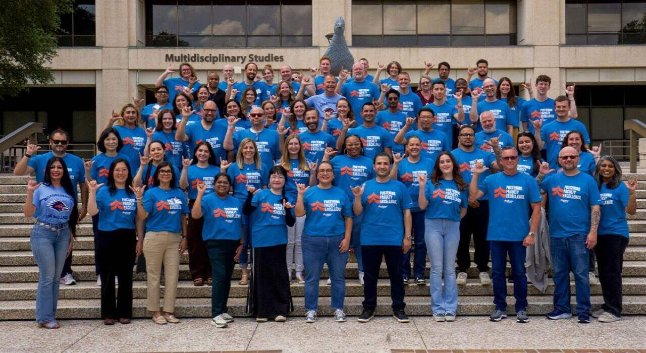 New faculty members stand in front of the Roadrunner Statue