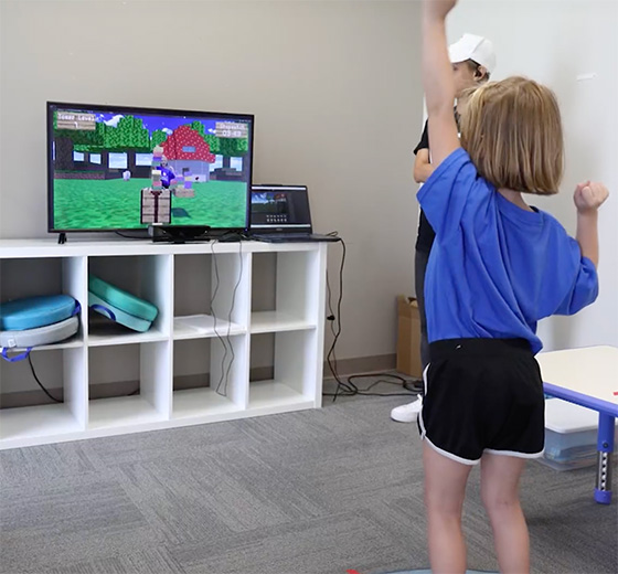 A Camp Durango participant plays a game that places the child in an augmented reality Minecraft world.