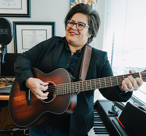 Rachel Cruz play the guitar during a recording session