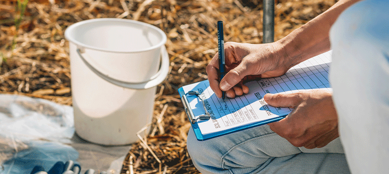 Researcher collecting data on dirt