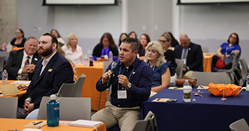 An attendee asks a question to the panelists
