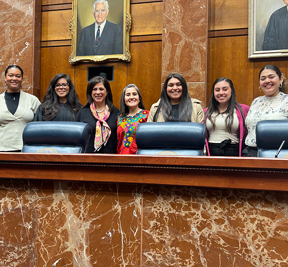 Dr. Claudia Garcia-Louis and her research team with Justice Rebecca Huddle.