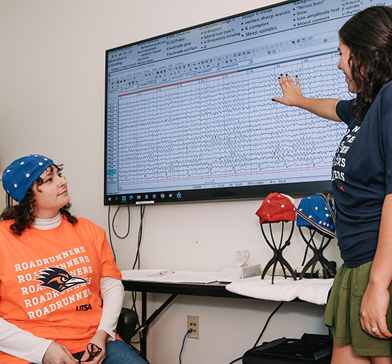 Neurofeedback researcher talks with her patient.