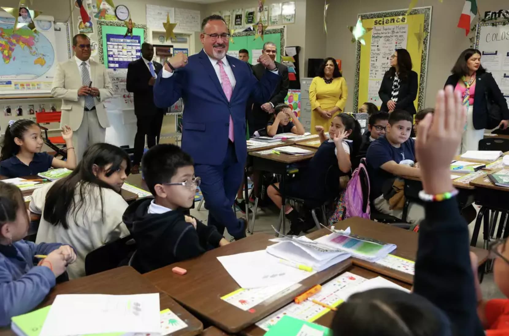  U.S. Secretary of Education Miguel Cardona engages third grade students during a tour of Mark Twain Dual Language Academy in October 2023. 