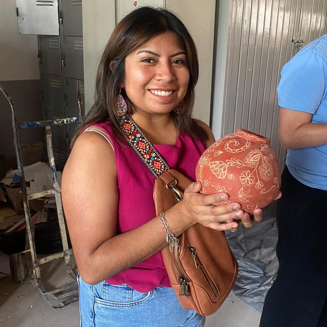 Hair Hernandez holds a piece of pottery in Guadalajara, Mexico