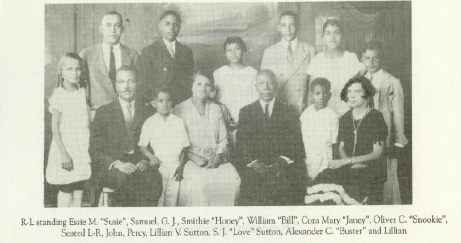 Lillian V. Sutton (center left) and Samuel J. Sutton (center right) photographed with the entire Sutton family