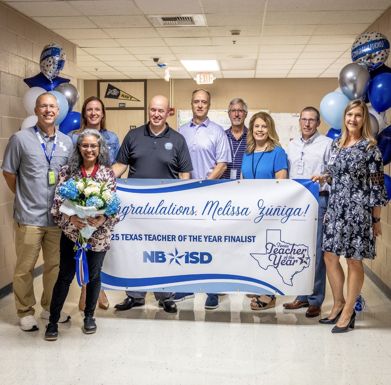 Ms. Melissa Farias Zúñiga presented with a banner for being named one of six state finalists for the Texas Association of School Administrators (TASA) Texas Teacher of the Year Award