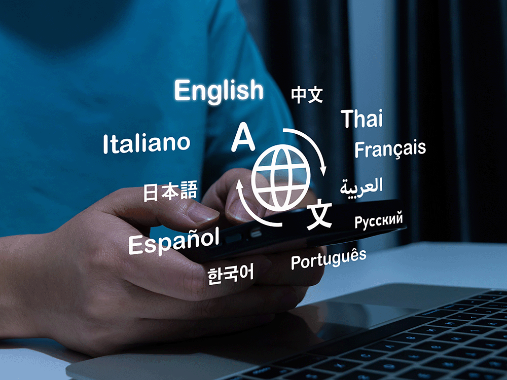 Student holding phone in front of laptop