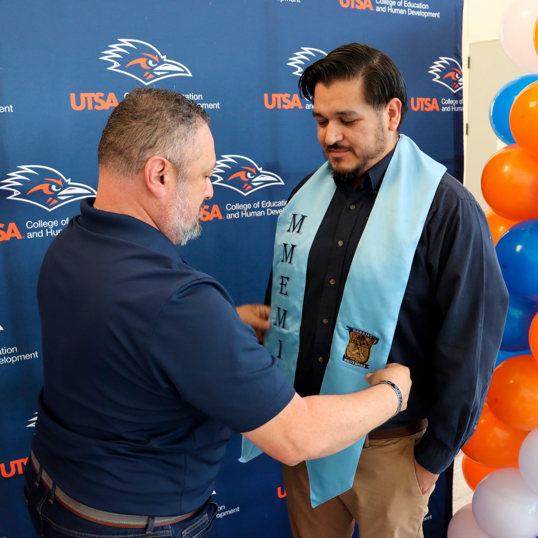 Xavier Loredo places a stole on a student before the New Teacher Induction Ceremony