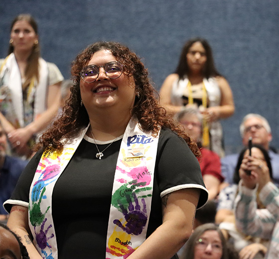 A graduate recites the Teacher Affirmation during the New Teacher Induction Ceremony.