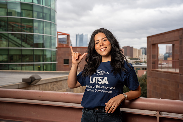 Student with birds up sign
